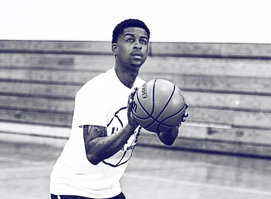 Coach Howard shooting a basketball in the gym